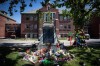 Flowers and cards are left at a makeshift memorial at a monument outside the former Kamloops Indian Residential School to honour the 215 children whose remains are believed to have been discovered buried near the city in Kamloops, B.C., on Monday, May 31, 2021. THE CANADIAN PRESS/Darryl Dyck