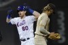 New York Mets' Billy McKinney (60) celebrates after hitting an RBI-double during the fifth inning of a baseball game as San Diego Padres shortstop Fernando Tatis Jr. looks on Friday, June 11, 2021, in New York. (AP Photo/Frank Franklin II)