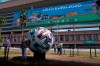 People take photographs outside the La Cartuja stadium in Seville, Spain, Saturday, June 12, 2021. The stadium will host the games of Group E and one of the round of 16 for the Euro 2020 soccer. (AP Photo/Thanassis Stavrakis)