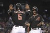 Arizona Diamondbacks' Eduardo Escobar (5) and Christian Walker celebrate after scoring runs against the Los Angeles Angels on a ball hit by David Peralta in the third inning during a baseball game, Saturday, June 12, 2021, in Phoenix. (AP Photo/Rick Scuteri)