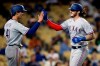 Texas Rangers' Jonah Heim, right, gets congratulations from Eli White after hitting a two-run home run against the Los Angeles Dodgers during the fourth inning of a baseball game in Los Angeles, Saturday, June 12, 2021. (AP Photo/Alex Gallardo)