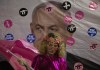 An Israeli protester wears pink during a demonstration against Israeli Prime Minister Benjamin Netanyahu outside his official residence in Jerusalem, Saturday, June 12, 2021. If all goes according to plan, Israel will swear in a new government on Sunday, ending Prime Minister Benjamin Netanyahu's record 12-year rule and a political crisis that inflicted four elections on the country in less than two years. Hebrew reads: 