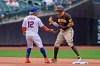 San Diego Padres' Manny Machado, right, and New York Mets shortstop Francisco Lindor tease one another during the first inning of a baseball game at Citi Field, Sunday, June 13, 2021, in New York. (AP Photo/Seth Wenig)