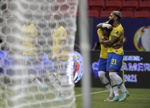 Brazil's Gabriel Barbosa, right, celebrates scoring his side's third goal against Venezuela with teammate Neymar during a Copa America soccer match at the National Stadium in Brasilia, Brazil, Sunday, June 13, 2021. (AP Photo/Eraldo Peres)