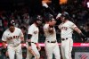 San Francisco Giants' Mike Yastrzemski, second from right, celebrates after hitting a grand slam home run that scored LaMonte Wade Jr., from left, Brandon Belt and Curt Casali during the eighth inning of a baseball game against the Arizona Diamondbacks in San Francisco, Tuesday, June 15, 2021. (AP Photo/Jeff Chiu)