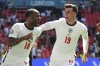 England's Raheem Sterling, left, celebrates with England's Mason Mount after scoring his side's opening goal during the Euro 2020 soccer championship group D match between England and Croatia at Wembley stadium in London, Sunday, June 13, 2021. (Glyn Kirk/Pool Photo via AP)