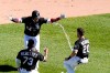 Chicago White Sox's Yasmani Grandal, center, celebrates his game winning single with Yermin Mercedes, left, and Danny Mendick, right, during the 10th inning of a baseball game against the Tampa Bay Rays Wednesday, June 16, 2021, in Chicago. (AP Photo/Charles Rex Arbogast)