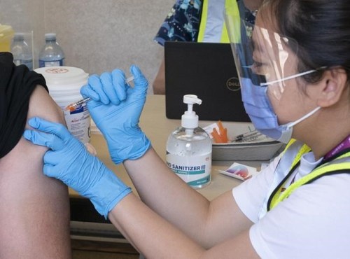 Inderpal Singh receives his vaccination for COVID-19 in a trailer parked at a truck stop along highway 91 North in Delta, B.C., Wednesday, June 16, 2021. THE CANADIAN PRESS/Jonathan Hayward