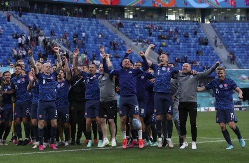 Slovakian players celebrate at the end of the Euro 2020 soccer championship group E match between Poland v Slovakia at the Saint Petersburg stadium in St. Petersburg, Russia, Monday, June 14, 2021. (Evgenya Novozhenina/Pool via AP)