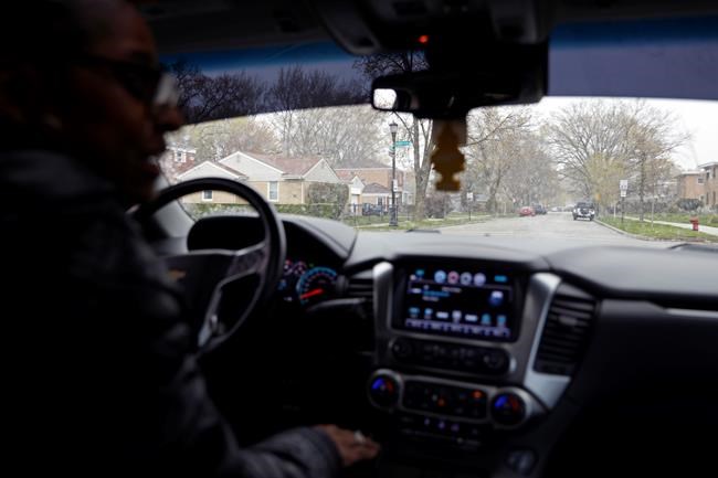 Kimberly Ross-Holmes drives through Evanston fifth ward, where she spent her childhood, Friday, April 23, 2021. The Chicago suburb will become the first to pay reparations in the form of housing grants. She said she is glad that Juneteenth will be a federal holiday, but hopes that the federal government takes up more issues that affect the everyday lives of Black people. (AP Photo/Shafkat Anowar)