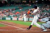 Houston Astros' Michael Brantley (23) hits a three-run home run as Chicago White Sox catcher Yasmani Grandal reaches for the pitch during the first inning of a baseball game Thursday, June 17, 2021, in Houston. (AP Photo/David J. Phillip)