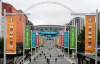 People walk the road to Wembley stadium during the Euro 2020 soccer championship in London, Thursday, June 17, 2021. England is facing Scotland in a group D match on Friday evening at Wembley stadium. (AP Photo/Frank Augstein)