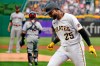 Pittsburgh Pirates' Gregory Polanco (25) returns to the dugout after hitting a two-run home run off Cleveland Indians pitcher Jean Carlos Mejia, left, during the first inning of a baseball game in Pittsburgh, Friday, June 18, 2021. (AP Photo/Gene J. Puskar)