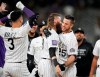 Colorado Rockies' C.J. Cron, right, is congratulated by Charlie Blackmon, center, and Dom Nunez after Cron drove in the winning run in the 10th inning of a baseball game against the Milwaukee Brewers on Friday, June 18, 2021, in Denver. The Rockies won 6-5. (AP Photo/David Zalubowski)