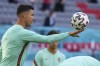Portugal's Cristiano Ronaldo controls the ball during a training session at the football arena stadium in Munich, Friday, June 18, 2021 the day before the Euro 2020 soccer championship group F match between Portugal and Germany. (AP Photo/Matthias Schrader)