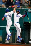 Texas Rangers' Isiah Kiner-Falefa (9) celebrates his two-run home run against the Minnesota Twins with Adolis Garcia, right, during the third inning of a baseball game Saturday, June 19, 2021, in Arlington, Texas. (AP Photo/Michael Ainsworth)