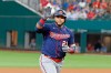 Minnesota Twins' Nelson Cruz (23) waves to family in the stands as he celebrates his two-run home run against the Texas Rangers during the fourth inning of a baseball game Saturday, June 19, 2021, in Arlington, Texas. (AP Photo/Michael Ainsworth)
