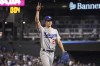 Los Angeles Dodgers pitcher Walker Buehler acknowledges fans while leaving in the eighth inning of the team's baseball game against the Arizona Diamondbacks, Saturday, June 19, 2021, in Phoenix. (AP Photo/Rick Scuteri)