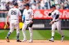 New York Yankees DJ LeMahieu, left, Tyler Wade, center, and Clint Frazier, right, celebrate after the Yankees completed a triple play to defeat the Oakland Athletics in the top of the ninth inning of a baseball game, Sunday, June 20, 2021, at Yankee Stadium in New York. (AP Photo/Kathy Willens)