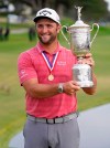 Jon Rahm, of Spain, holds the champions trophy for photographers after the final round of the U.S. Open Golf Championship, Sunday, June 20, 2021, at Torrey Pines Golf Course in San Diego. (AP Photo/Marcio Jose Sanchez)