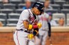 Atlanta Braves' Ronald Acuña Jr. reacts while crossing the plate after hitting a solo home run during the fifth inning of the second baseball game of a doubleheader against the New York Mets, Monday, June 21, 2021, in New York. (AP Photo/Kathy Willens)