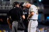 Milwaukee Brewers relief pitcher Trevor Richards, right, turns his belt around as umpires D.J. Reyburn, left, and Brian O'Nora, center, examine his belt, glove and cap during the second inning of a baseball game against the Arizona Diamondbacks, Monday, June 21, 2021, in Phoenix. Beginning Monday, Major League Baseball will enhance its enforcement of rules that prohibit applying foreign substances to baseballs. (AP Photo/Ross D. Franklin)