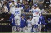 Los Angeles Dodgers' Mookie Betts (50) is congratulated by Justin Turner (10) after hitting a solo home run during the third inning of a baseball game against the San Diego Padres, Monday, June 21, 2021, in San Diego. (AP Photo/Denis Poroy)