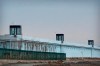 A person stands in a tower on the perimeter of the Number 3 Detention Center in Dabancheng in western China's Xinjiang Uyghur Autonomous Region on April 23, 2021. Human rights groups and Western nations led by the United States, Britain and Germany accused China of massive crimes against the Uyghur minority and demanded unimpeded access for U.N. experts at a virtual meeting on Wednesday, May 12, 2021 denounced by China as 