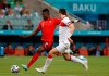 Turkey's Caglar Soyuncu, right, tries to block a shot by Switzerland's Breel Embolo during the Euro 2020 soccer championship group A match between Switzerland and Turkey at the Baku Olympic Stadium in Baku, Azerbaijan, Sunday, June 20, 2021. (Valentyn Ogirenko/Pool via AP)