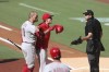 Cincinnati Reds' Joey Votto (19) is held back by manager David Bell, center, while arguing with umpire Ryan Additon after being called out on a checked swing in the first inning of a baseball game against the San Diego Padres, Saturday, June 19, 2021, in San Diego. (AP Photo/Derrick Tuskan)