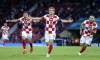 Croatia's Luka Modric, center, celebrates after scoring his side's second goal during the Euro 2020 soccer championship group D match between Croatia and Scotland at the Hampden Park Stadium in Glasgow, Tuesday, June 22, 2021.(Robert Perry/Pool via AP))