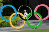 A man walks past the Olympic rings in Tokyo, Monday, June 7, 2021. THE CANADIAN PRESS/AP/Koji Sasahara