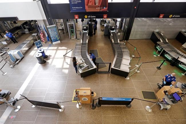 FILE - In this May 18, 2020, file photo, a lone traveler goes through a security check point at Seattle Tacoma International Airport, in SeaTac, Wash. Airports around the country will share $8 billion in federal relief to help them recover from the pandemic. The Federal Aviation Administration announced the grants on Tuesday, June 22, 2021. (AP Photo/Elaine Thompson, File)