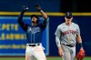 Tampa Bay Rays' Wander Franco, left, celebrates his double off Boston Red Sox relief pitcher Josh Taylor during the seventh inning of a baseball game Tuesday, June 22, 2021, in St. Petersburg, Fla. Looking on Boston's Kike Hernandez. (AP Photo/Chris O'Meara)