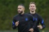 Memphis Depay, left, and Luuk de Jong, rear, warm up during the training of the Netherlands team in Zeist, Netherlands, Sunday, June 20, 2021, a day before the Euro 2020 soccer championship group C match between The Netherlands and North Macedonia. (AP Photo/Peter Dejong)