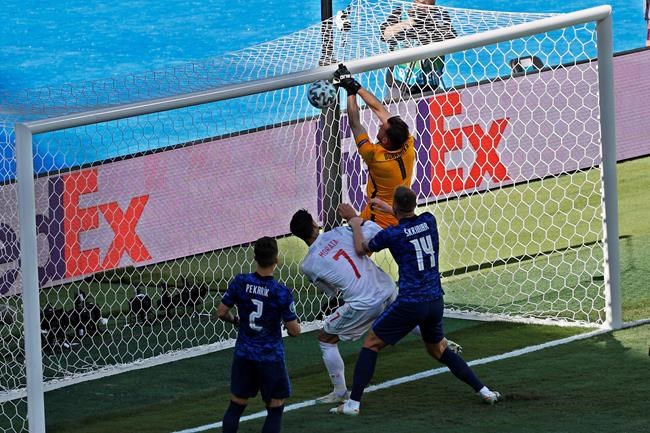 Slovakia's goalkeeper Martin Dubravka scores an own-goal while attempting to clear the ball during the Euro 2020 soccer championship group E match between Slovakia and Spain at La Cartuja Stadium in Seville, Spain, Wednesday June. 23, 2021. (Julio Munoz, Pool Photo via AP)