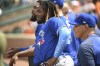 Toronto Blue Jays Vladimir Guerrero Jr. looks on from the dugout while wearing an arm sleeve with the words 