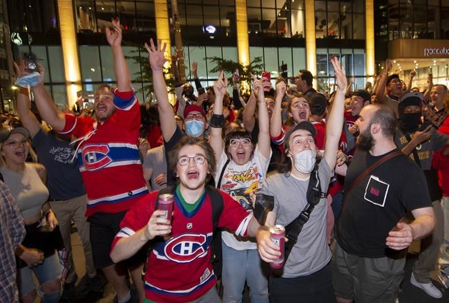 Montreal Canadiens fans celebrate on Rue Rene Levesque after the Montreal Canadiens defeated the Vegas Golden Knights in overtime game 6 NHL Stanley Cup playoff hockey semifinal action in Montreal, Thursday, June 24, 2021. The Canadiens will advance to the Stanley Cup final. THE CANADIAN PRESS/Peter McCabe