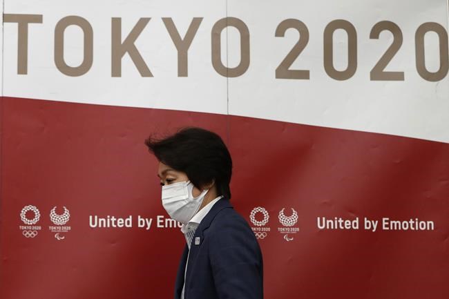 Tokyo 2020 Olympics Organizing Committee President Seiko Hashimoto arrives at a news conference after a meeting with local municipalities working group hosted by the government in Tokyo Wednesday, June 23, 2021, on the day to mark one month to go until the opening of the Olympic Games. (Issei Kato/Pool Photo via AP)