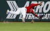 Texas Rangers center fielder Adolis Garcia is unable to catch a ball hit for an RBI triple by Kansas City Royals' Whit Merrifield during the third inning of a baseball game, Friday, June 25, 2021, in Arlington, Texas. (AP Photo/Brandon Wade)