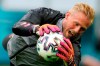 Denmark's goalkeeper Kasper Schmeichel dives for the ball during the training of his team at Johan Cruyff ArenA in Amsterdam, Netherlands, Friday, June 25, 2021, a day before the Euro 2020 soccer championship round of 16 match between Wales and Denmark. (AP Photo/Peter Dejong)