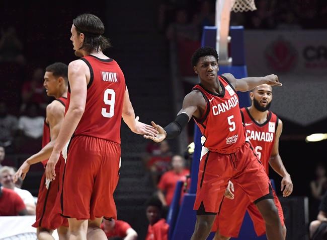 Canada's RJ Barrett (5) high fives Kelly Olynyk (9) after his basket against the Virgin Islands during first half FIBA Basketball World Cup 2019 Americas Qualifiers action, in Ottawa on Monday, July 2, 2018. Victoria will feel like home court for Canada's men's basketball team after all. Organizers for Canada's last-chance Olympic qualifying tournament which tips off Tuesday in Victoria have been given the green light to have fans at games.THE CANADIAN PRESS/Justin Tang
