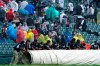 The Chicago White Sox grounds crew puts a tarp on the field during a rain delay in the third inning of a baseball game against the Seattle Mariners in Chicago, Saturday, June 26, 2021. (AP Photo/Nam Y. Huh)
