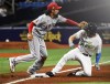 Tampa Bay Rays' Brett Phillips, right, beats the throw to Los Angeles Angels third baseman Anthony Rendon with a two-run triple during the fourth inning of a baseball game Saturday, June 26, 2021, in St. Petersburg, Fla. (AP Photo/Steve Nesius)