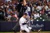 Milwaukee Brewers' Luis Urias, bottom, reacts after striking out against the Colorado Rockies during the second inning of a baseball game Saturday, June 26, 2021, in Milwaukee. (AP Photo/Jeffrey Phelps)
