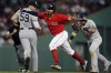 Boston Red Sox's Xander Bogaerts, center, is caught in a rundown by New York Yankees' Gleyber Torres, right, after Rafael Devers grounded into a double play during the fifth inning of a baseball game, Saturday, June 26, 2021, in Boston. (AP Photo/Michael Dwyer)