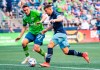 Vancouver Whitecaps attacker Lucas Cavallini, right, controls the ball against Seattle Sounders' Shane O'Neill during an MLS soccer match Saturday, June 26, 2021, in Seattle. (Dean Rutz/The Seattle Times via AP)
