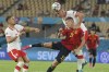 Spain's Dani Olmo, bottom, fights for the ball with Poland's Kamil Glik, above, during the Euro 2020 soccer championship group E match between Spain and Poland at La Cartuja stadium in Seville, Spain, Saturday, June 19, 2021. (David Ramos/Pool via AP)