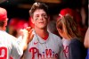Philadelphia Phillies players and coaches greet Philadelphia Phillies' Nick Maton, center, in the dugout after Maton scored on Odubel Herrera's second-inning sacrifice fly during a baseball game, Sunday, June 27, 2021, in New York. (AP Photo/Kathy Willens)