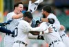 Detroit Tigers' Robbie Grossman (8) is surrounded by Zack Short, Akil Baddoo, and Jeimer Candelario after hitting a sacrifice fly ball to score Baddoo and defeat the Houston Astros in the 10th inning of a baseball game Sunday, June 27, 2021, in Detroit. (AP Photo/Duane Burleson)
